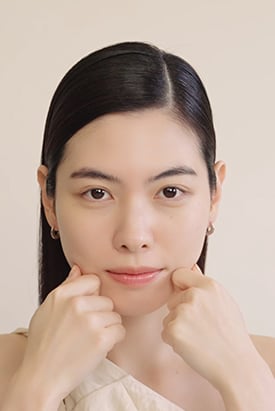 젊은 여성이 손으로 턱을 부드럽게 마사지하는 모습으로, 설화수 진세노사이드 크림 리치의 풍부한 영양감과 탄력있는 피부 표현을 보여줍니다.
